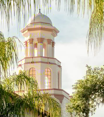 Exterior view of a facility tower surrounded by greenery
