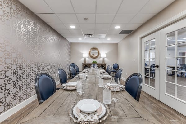 A stylish dining room setup with a long table