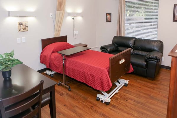 Comfortable resident room with a hospital bed and seating