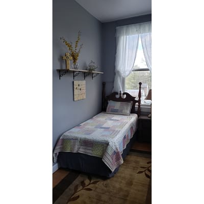 Cozy private room with bed and decor