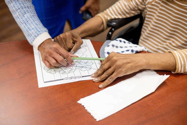 Resident and staff member engaging in an activity