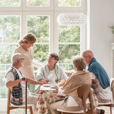 Residents enjoying a meal together in a bright dining area