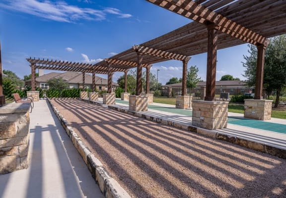 Outdoor seating area with pergola and pathways