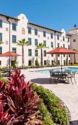 Outdoor pool area with seating and landscaping