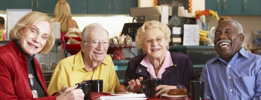 Residents enjoying coffee and pastries in a cozy cafe setting