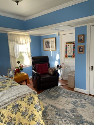 Cozy resident room with a chair and natural light