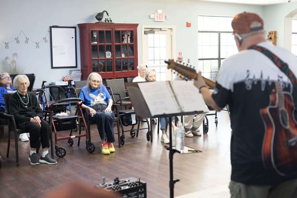 Residents enjoying live music in a common area