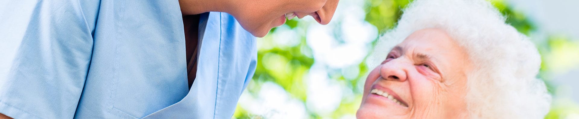 Caregiver interacting with a smiling elderly resident
