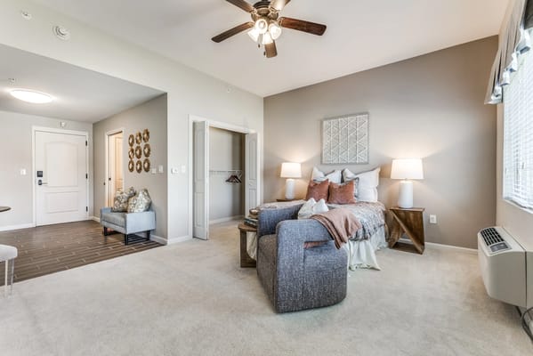 Cozy resident room with a bed and lounge area