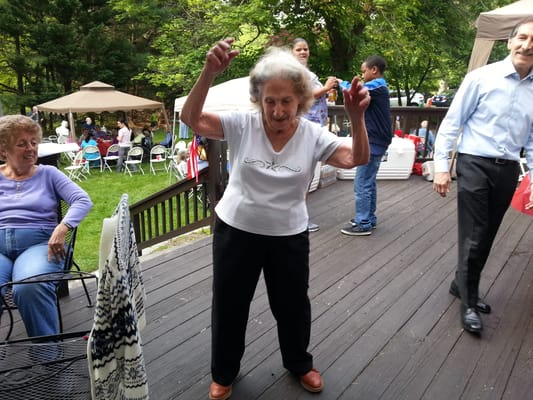 Residents enjoying a lively outdoor dance at a social event.