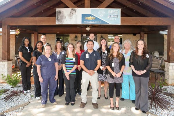 Staff posing in front of the nursing home entrance