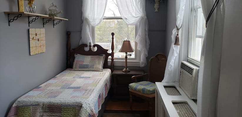 Cozy resident room with bed and chair