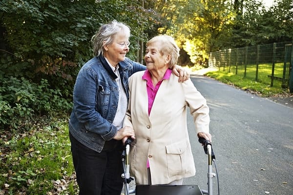 Two women enjoying a walk in a wooded area