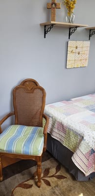 Cozy resident room with a bed and chair