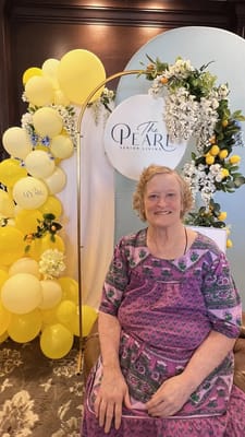 Resident smiling at a celebration with decorations