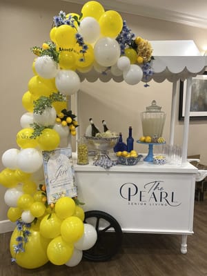 Decorative refreshment cart with flowers and balloons
