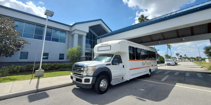 Facility shuttle bus at the entrance of the building