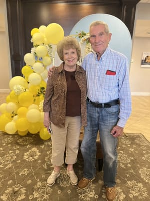 Residents smiling and celebrating in the lobby
