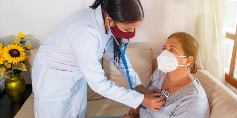 A healthcare professional checking a resident's vital signs