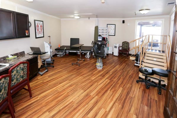 Rehabilitation room with exercise equipment and a therapy area