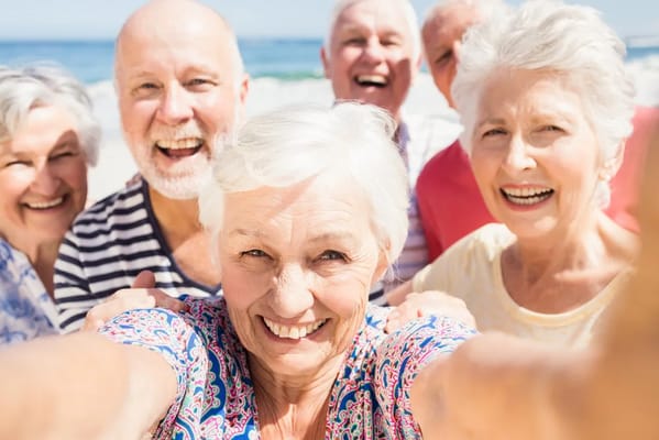Group of smiling seniors enjoying a day at the beach