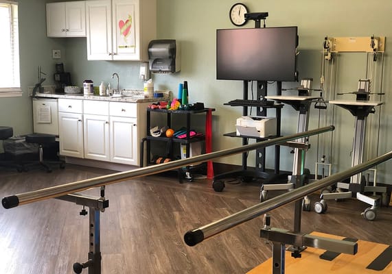 Physical therapy room with equipment and supplies