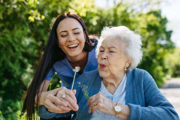A caregiver and a resident enjoying time outdoors