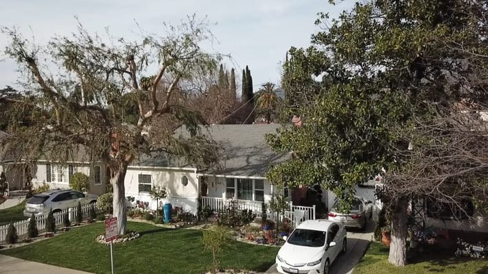 Exterior view of a residential facility with yard and trees