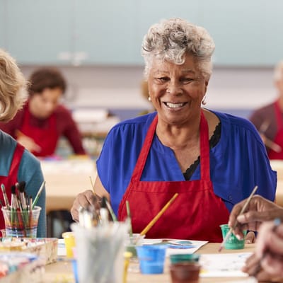 Residents participating in an art class with vibrant colors.