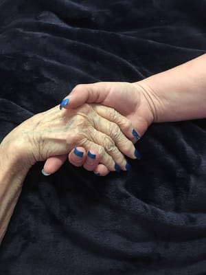 Two hands clasped together, symbolizing connection