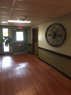 Interior hallway with decorative wall art and exit
