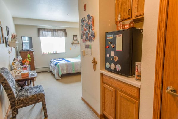 Interior view of a resident's room with kitchenette