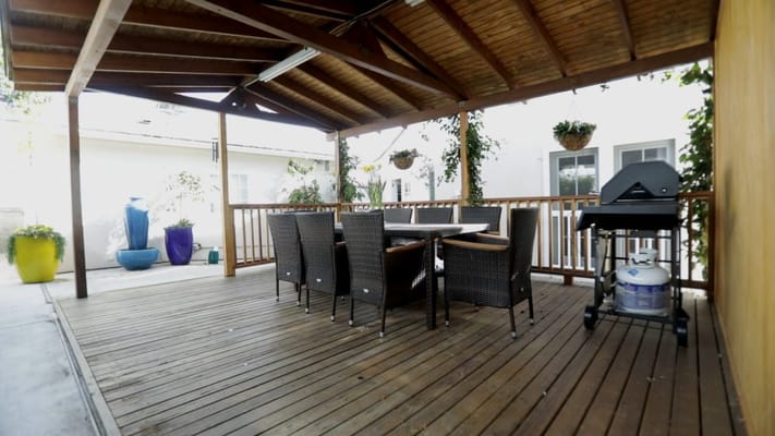 Outdoor dining area with seating and grill