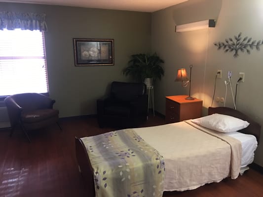 Cozy resident room with a bed and seating area