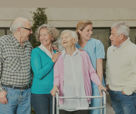 Residents and staff engaged in a joyful conversation