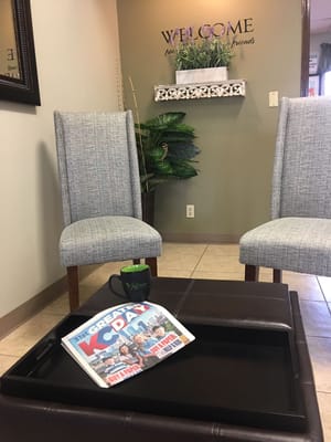 Cozy lounge area with chairs and a welcome sign