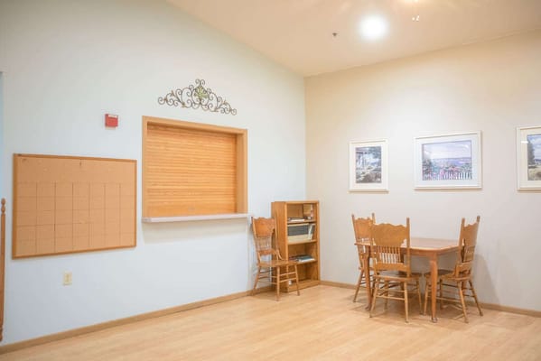 Light-filled common area with wooden chairs and tables
