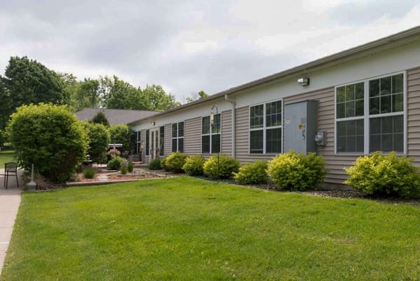 Exterior view of a senior living facility with gardens