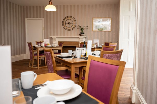 Bright dining room with tables set for meals