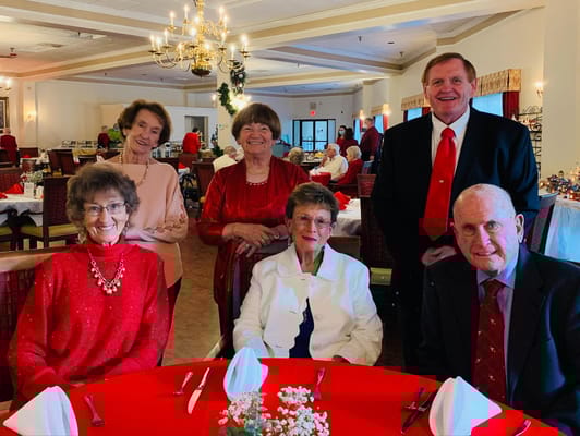 Residents and staff celebrating in a dining area