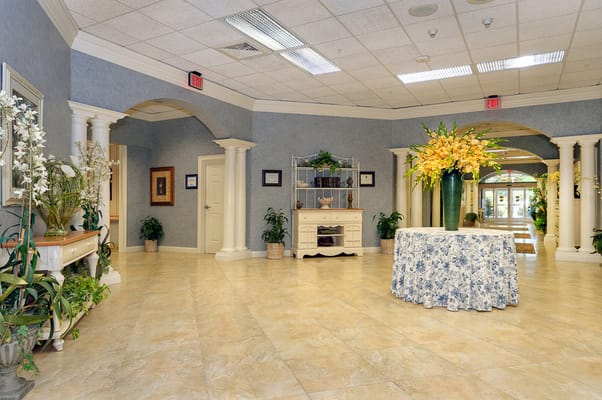 Interior view of a welcoming lobby with floral arrangements