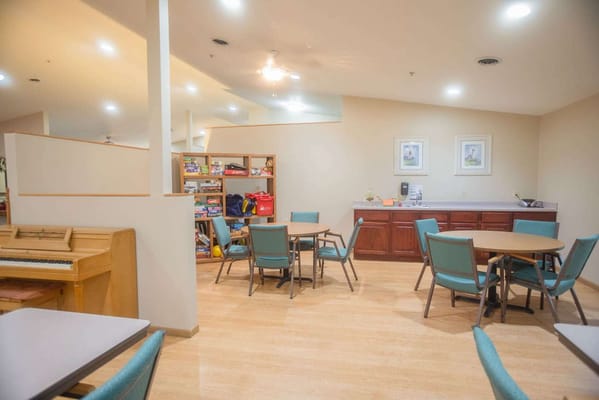 Interior common area with tables and a piano