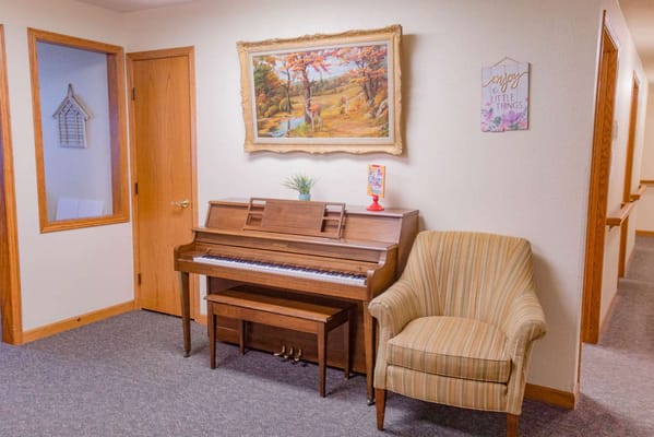 Piano and chair in a facility common area