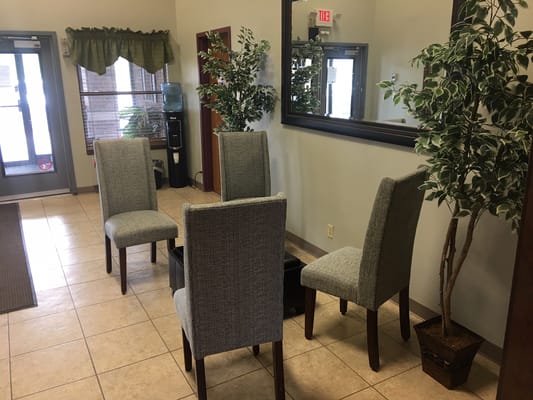 Interior of a facility lobby with chairs and plants