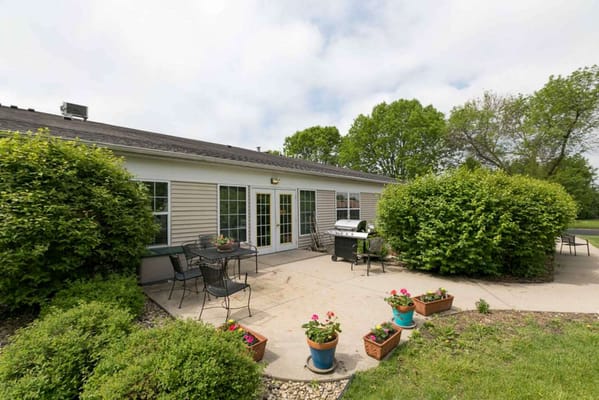 Outdoor seating area with planters and grill
