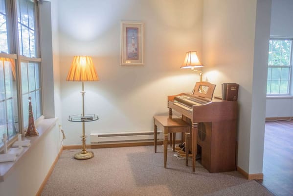 Interior corner with a piano and lamp