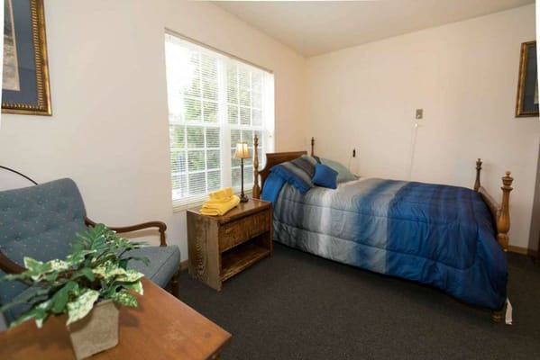 Cozy resident room with a bed and seating area