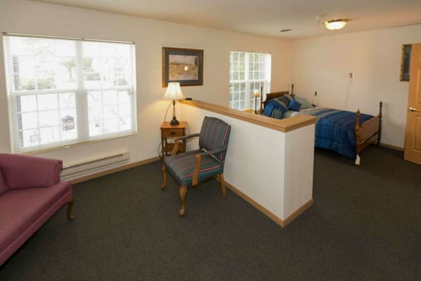 A well-furnished private resident room in a senior living facility