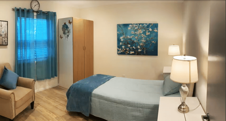 Cozy resident room with a bed and lamp