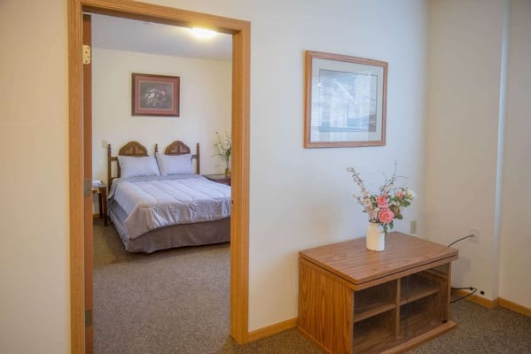 View of a cozy resident room with a bed and decor